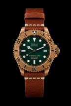 A Zulu brand wristwatch with a bronze-toned case, dark green dial, and brown leather strap, shown against a solid black background.